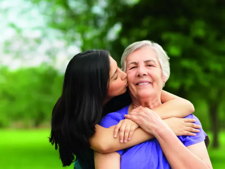 Daughter kissing mother
